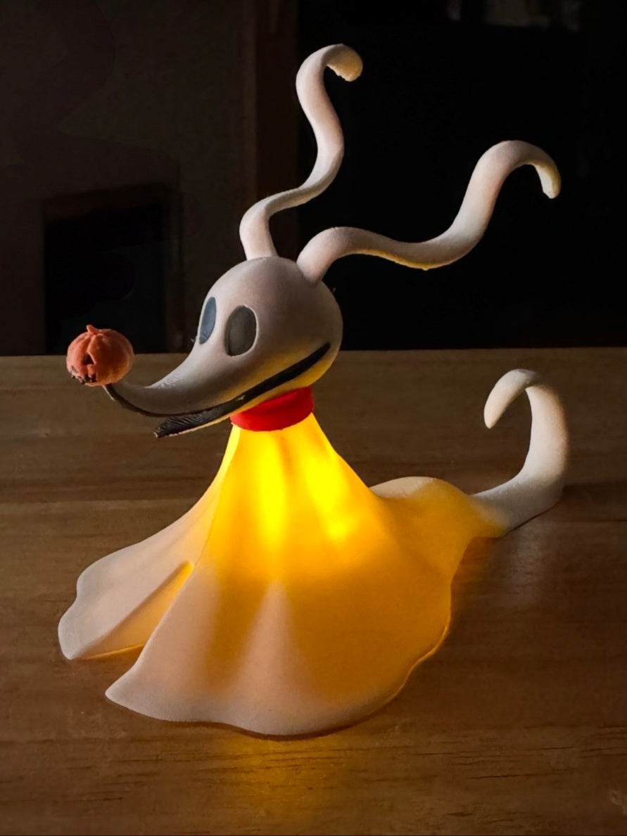White ghost-dog tealight holder with curled ears, red collar, black smiling face and orange pumpkin nose