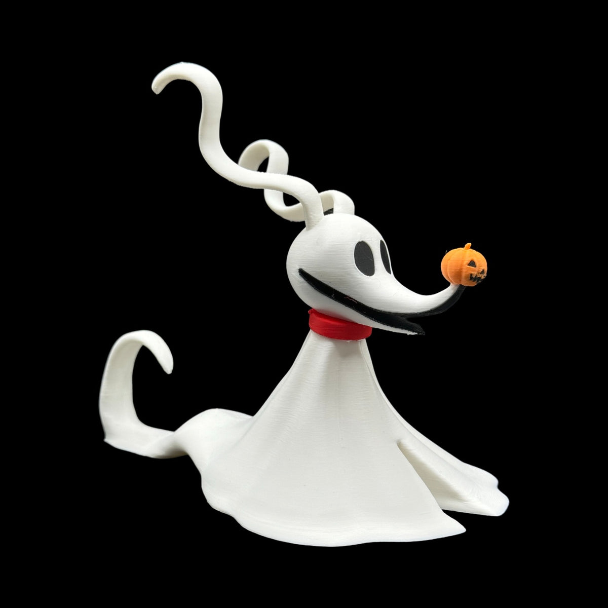 Ghost-dog tealight holder glowing warmly on a table, with its red collar, pumpkin nose and flowing body