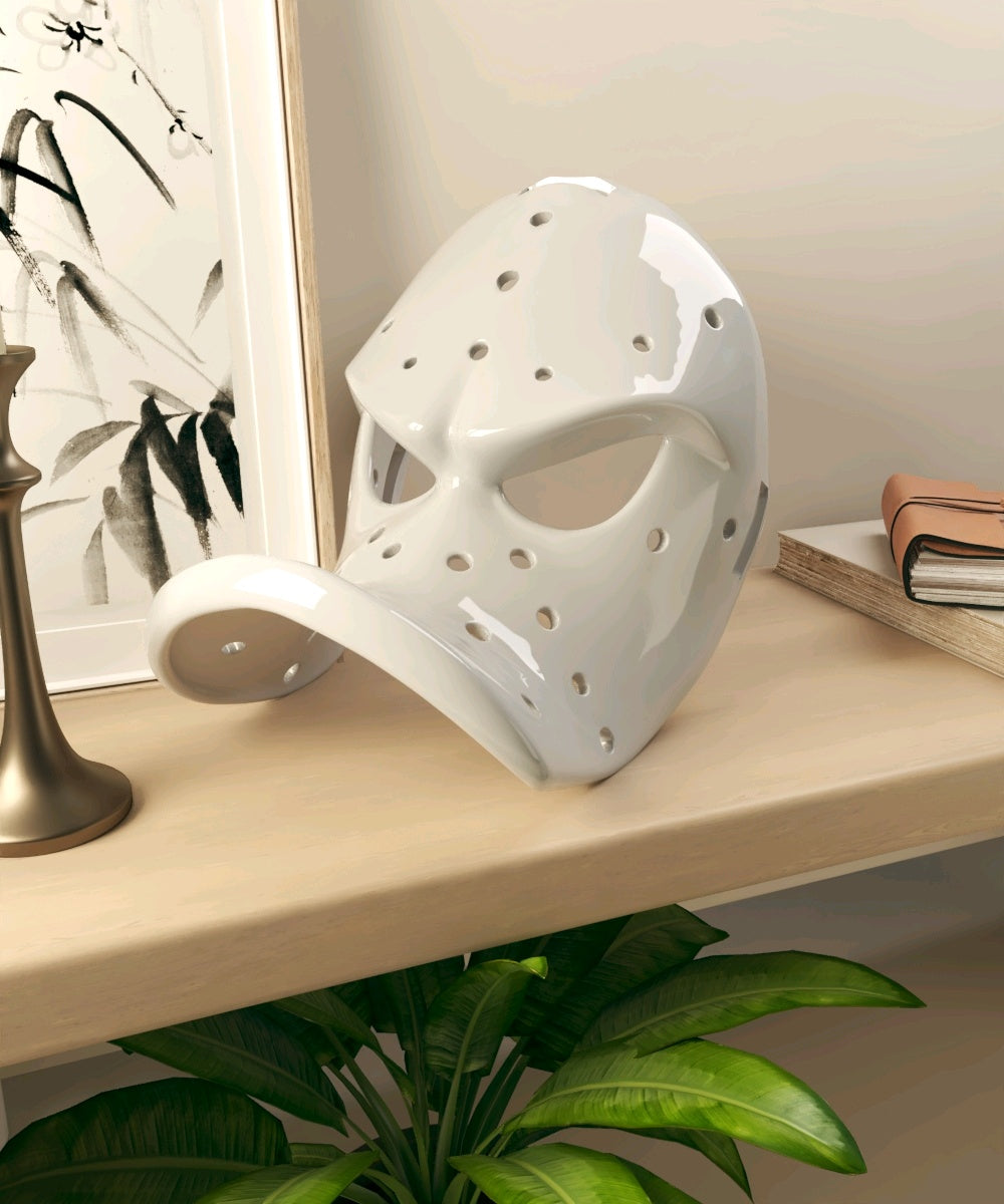 White perforated Duck Bill Mask displayed on a modern console
