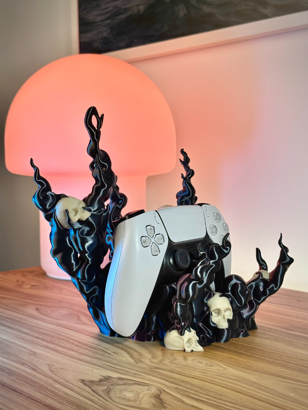 Front view of the dark sculptural skull flame controller holder with a controller seated inside