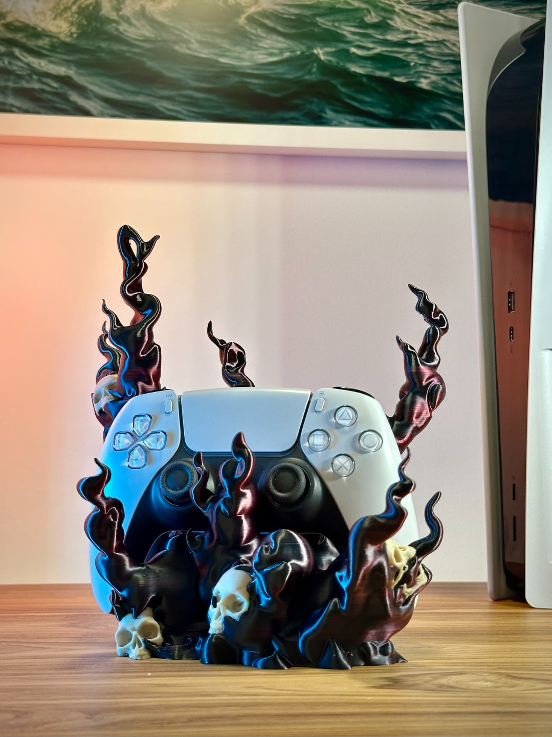 Skull flame controller holder beside a game console in a gaming room setup