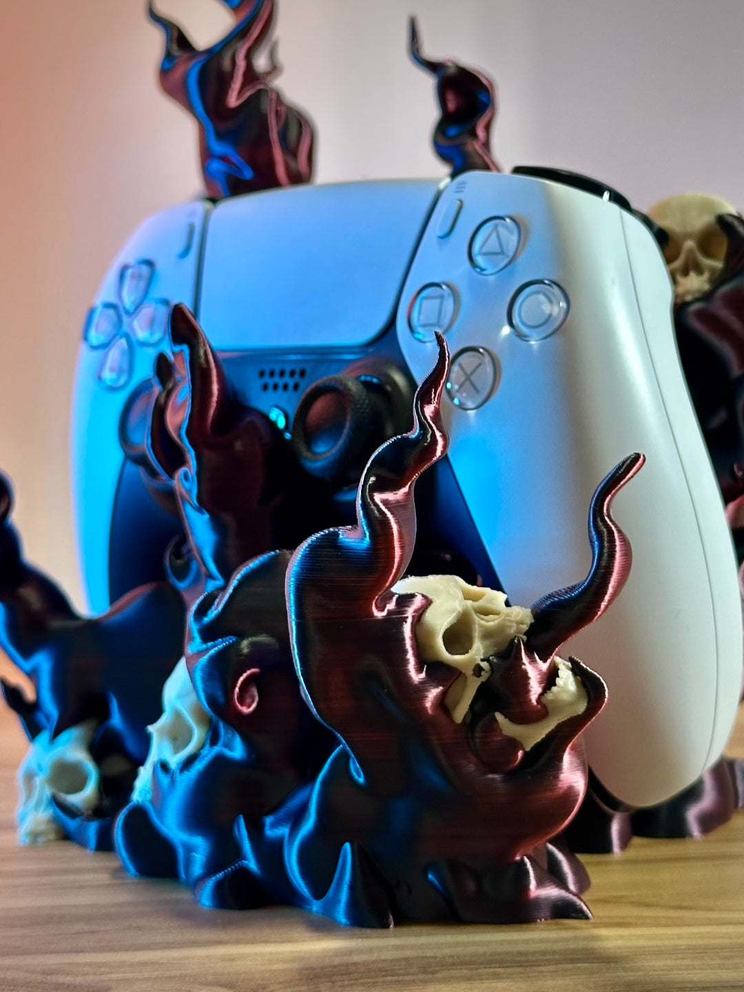 Angled side view of the black flame and skull controller holder with blue accent details