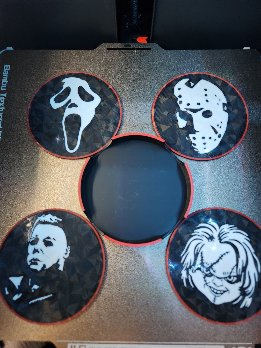 Set of four black, white and red horror character coffee coasters