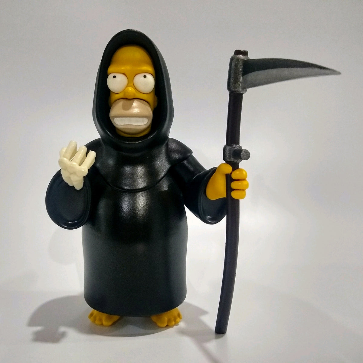 Horror Homer in a black hooded grim reaper robe holding a scythe