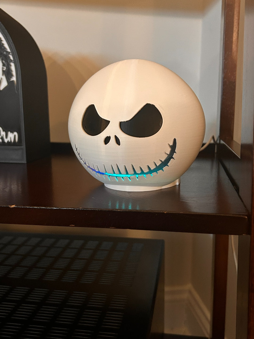 Jack Skellington Echo Dot skin fitted on a smart speaker from the side