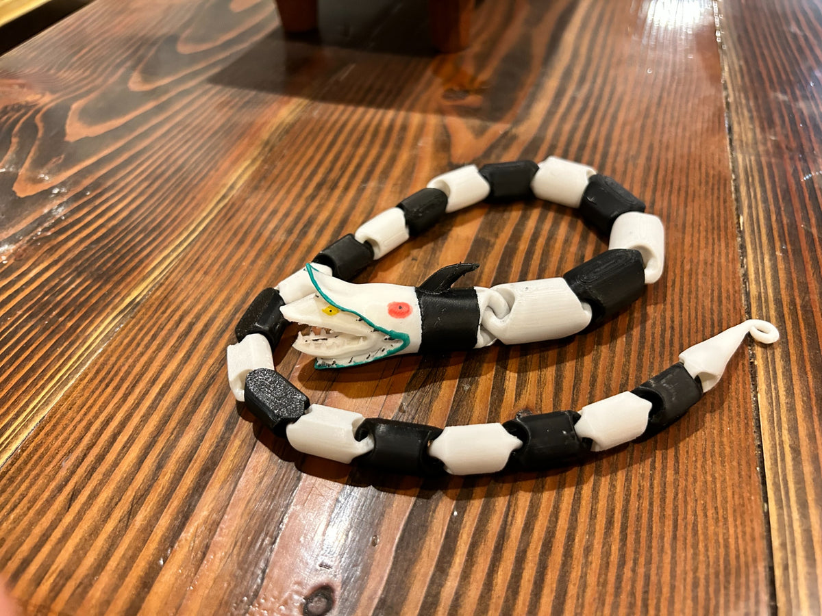 Close-up of the segmented Beetlejuice-inspired snake fidget toy