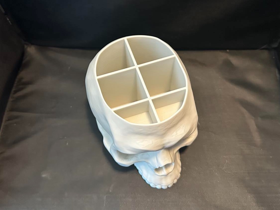 White skull desk organiser with six divided compartments, viewed from above