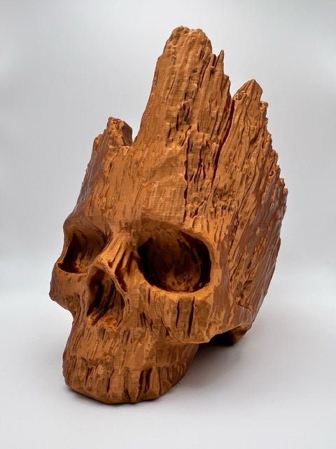 Brown skull sculpture with a tall jagged crown and carved wood-effect grain