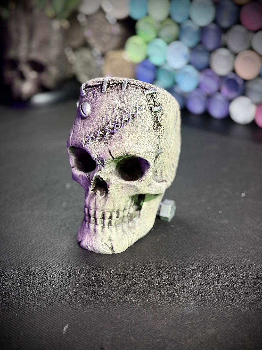 Pale textured skull with side bolt, crown fasteners and cracked details