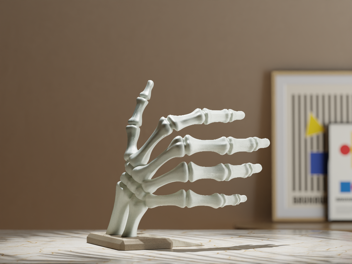 Unpainted skeleton hand book holder supporting colourful books