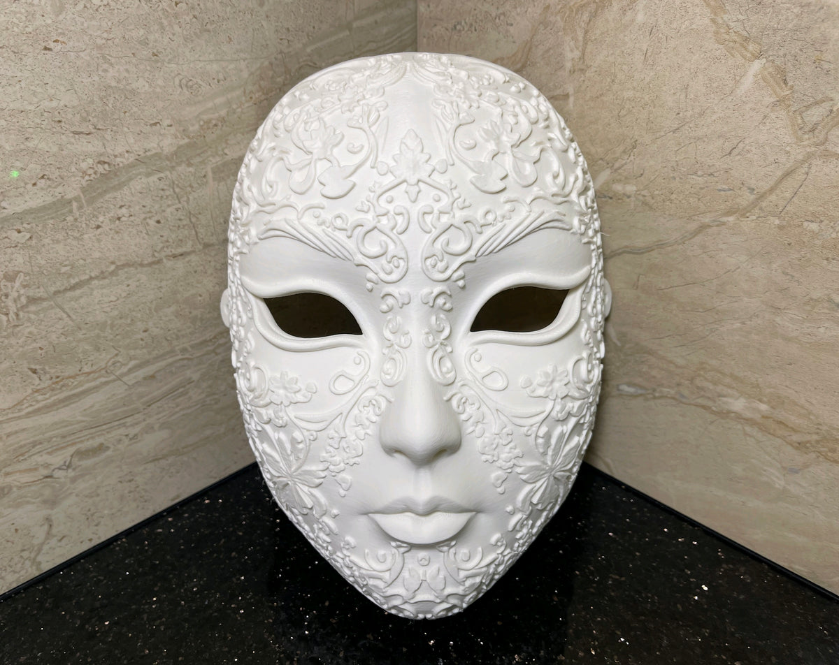 White Halloween Love Mask with raised floral scrollwork and dark eye openings