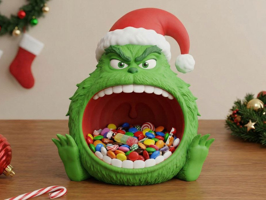 Green Christmas sweet bowl with an expressive face and red-and-white Santa hat