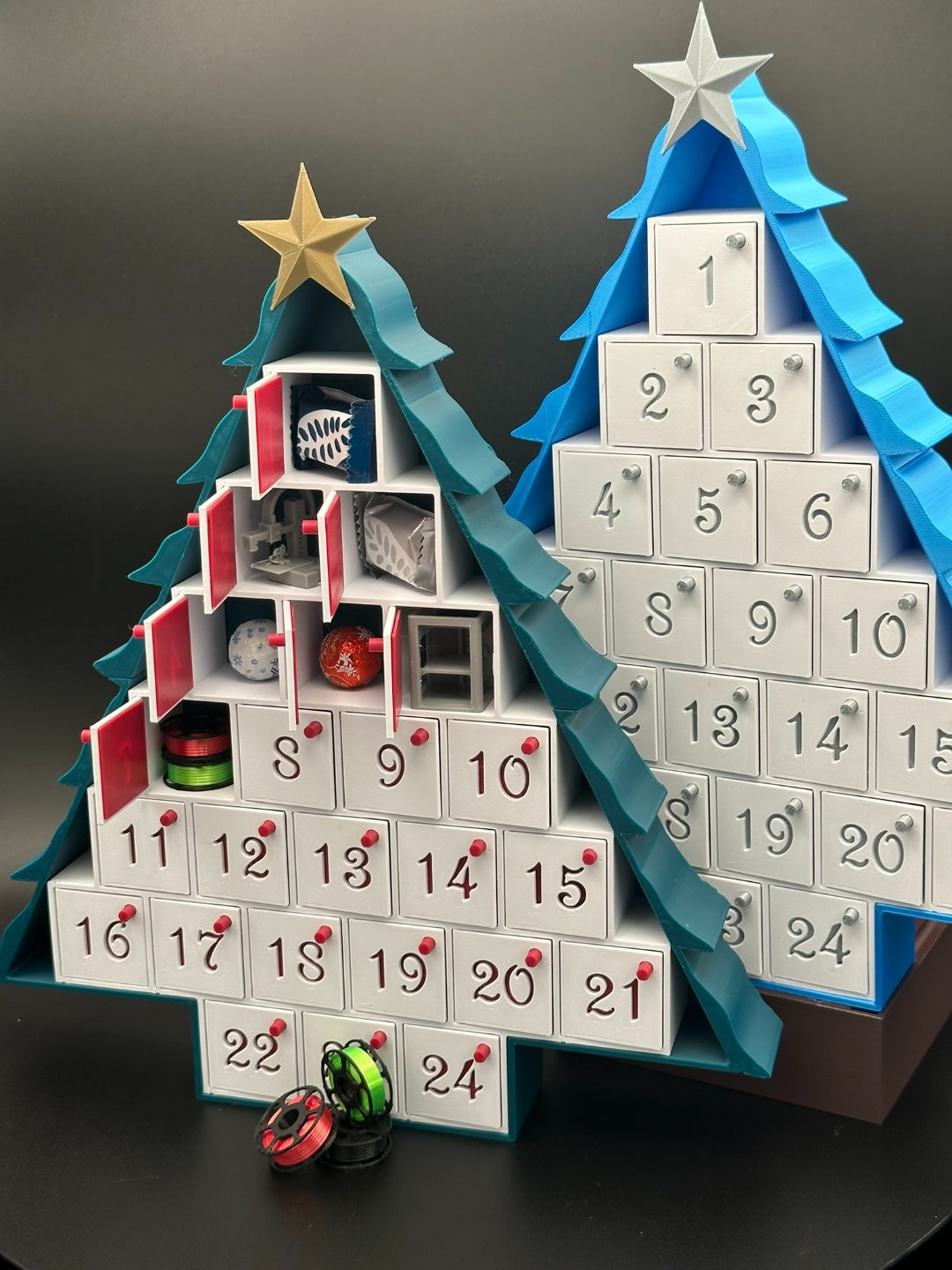 Tree-shaped Advent calendar with 24 numbered drawers and star topper, some drawers open