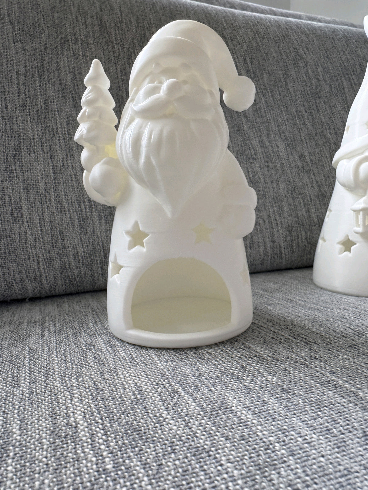 White bearded Santa holding a star, with a recessed tealight opening
