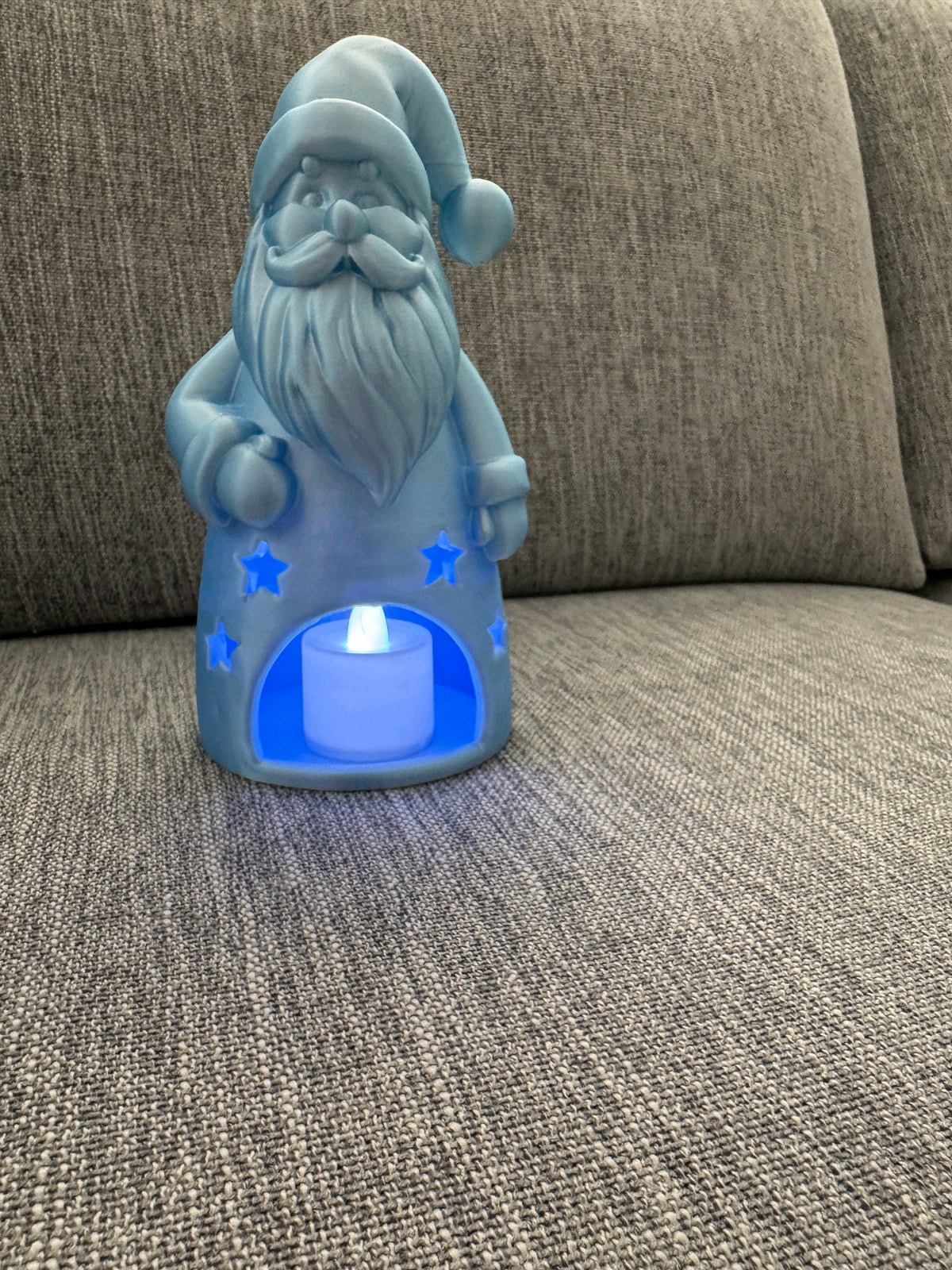 Front view of the bearded Santa tealight holder holding a small Christmas tree