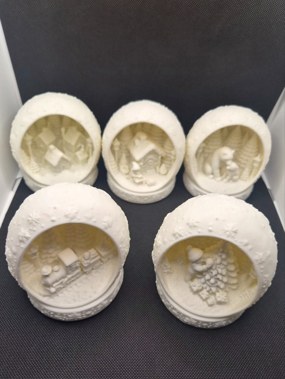 White snowflake-detailed round Christmas scene tealight holder.