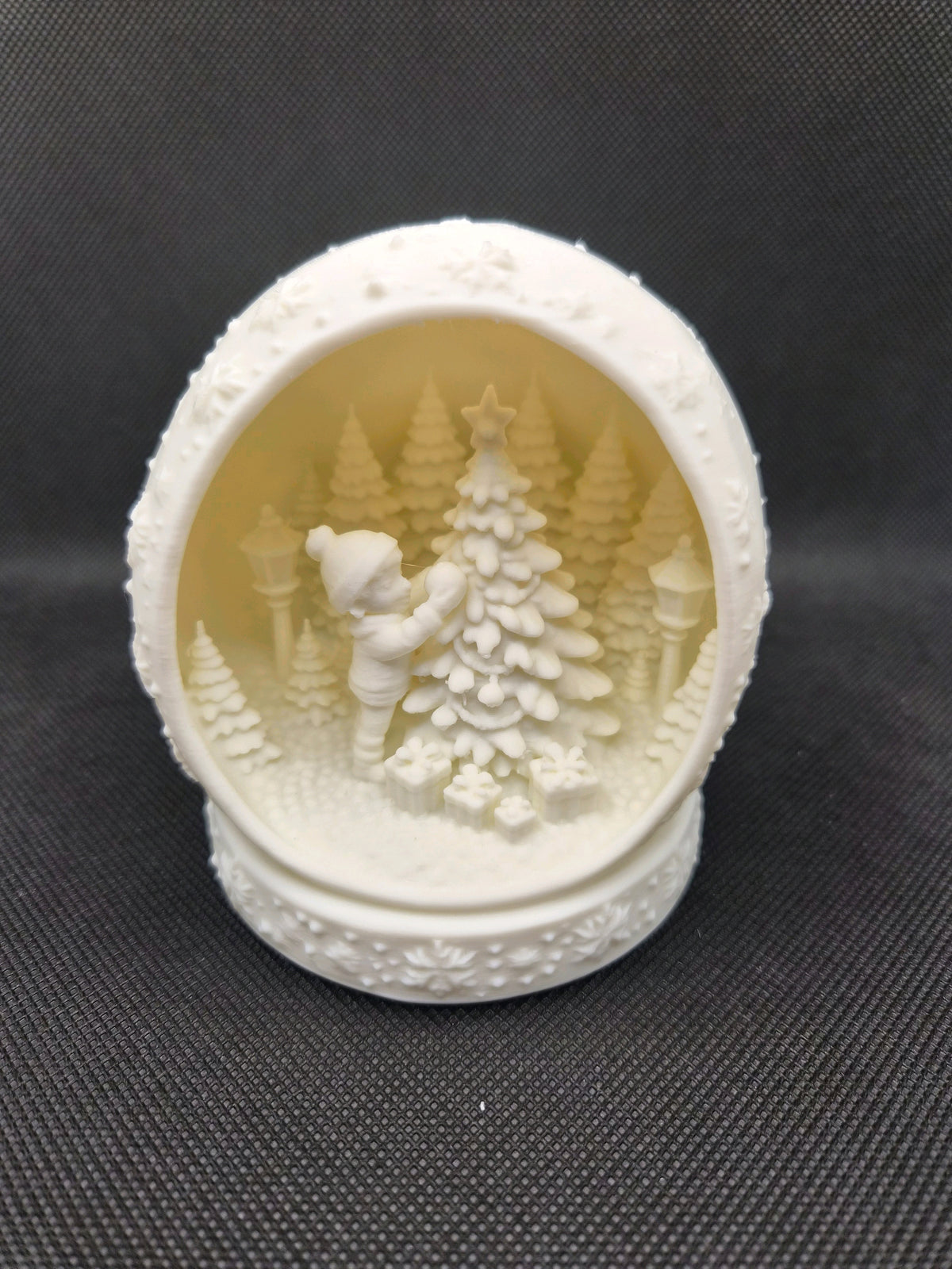 Five white spherical Christmas scene tealight holders arranged together.