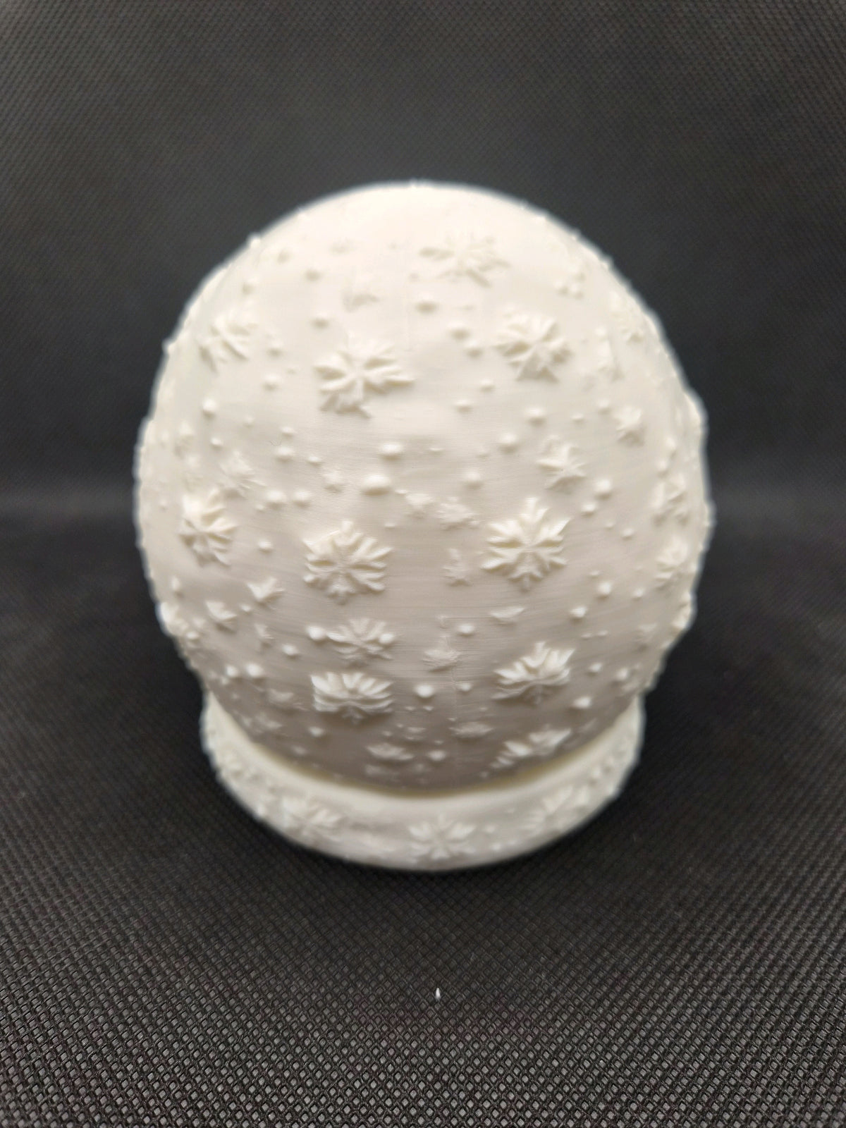 White Christmas scene tealight holder with a soft warm glow inside.