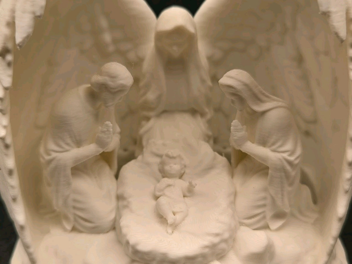 Full view of the wing-framed Nativity scene on its base