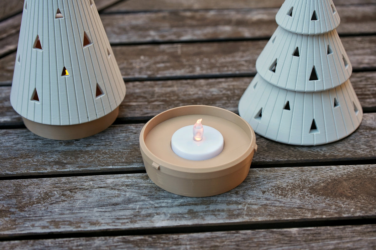 Open beige base with a battery-powered flameless LED tealight beside the two ribbed tree holders