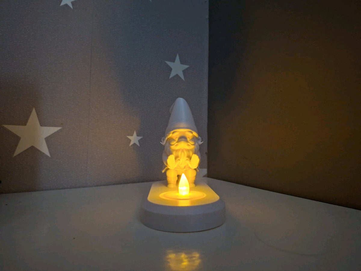 Side view of the Santa tealight holder showing the figure and oval base