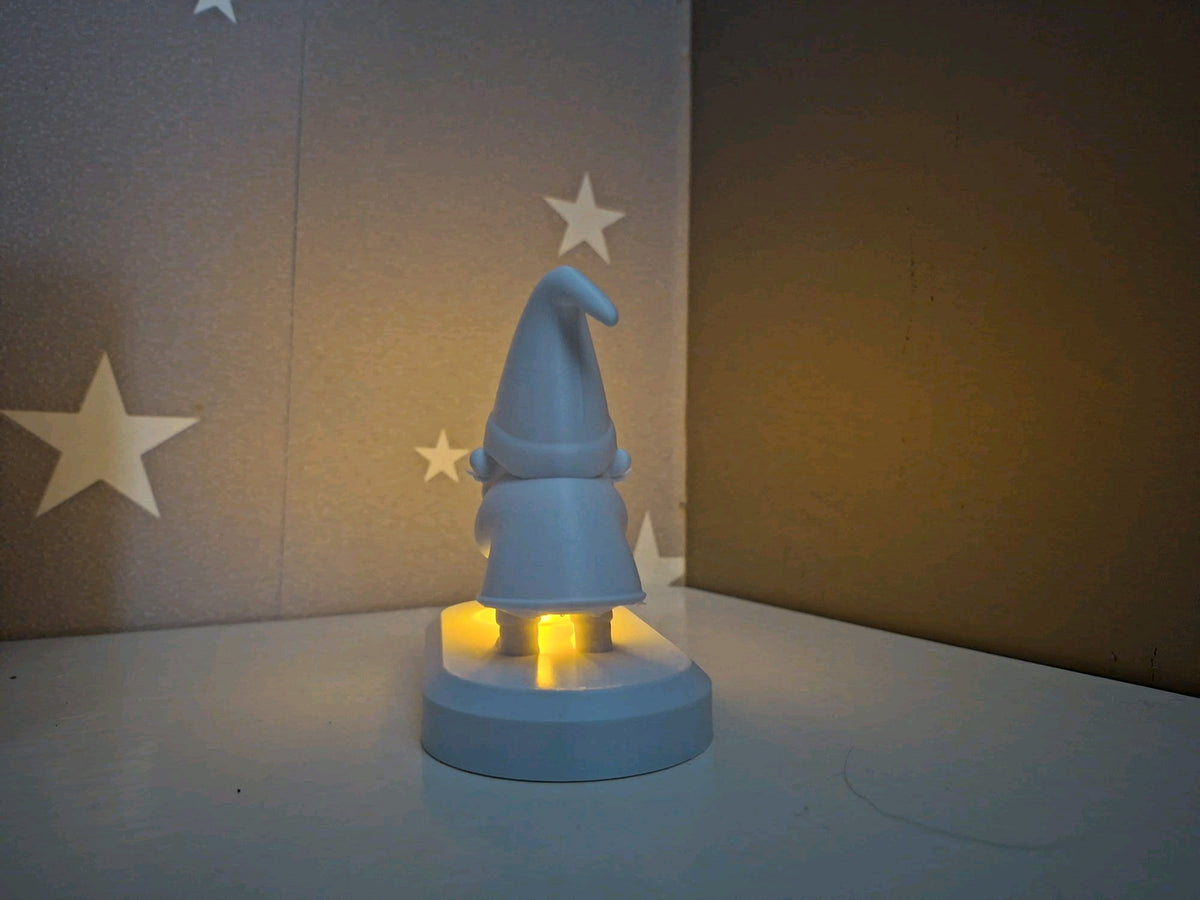 Rear view of the Santa figure and the back of the oval tealight base