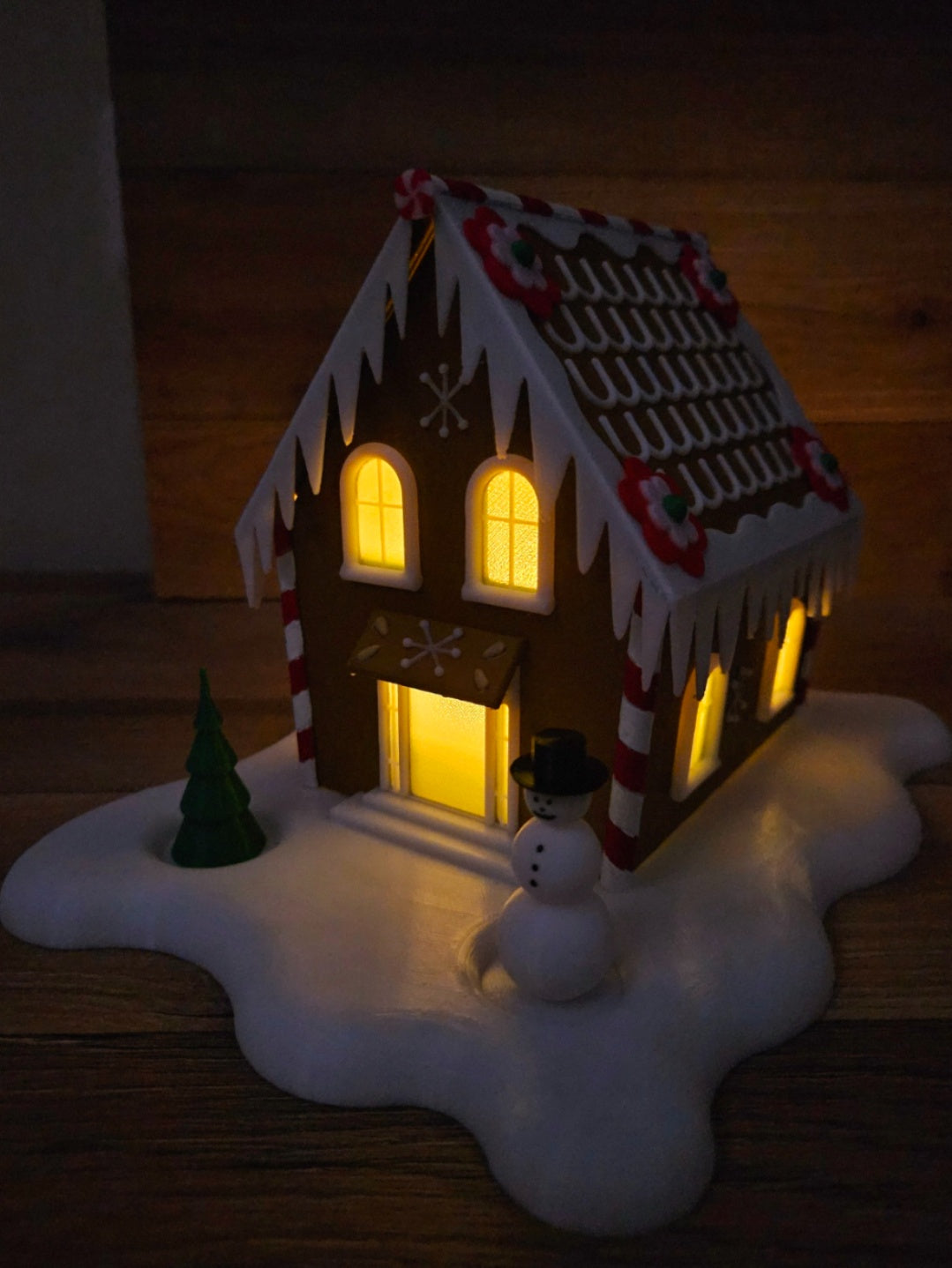 Gingerbread-style Christmas cabin tealight holder with iced roof, snowman and green tree
