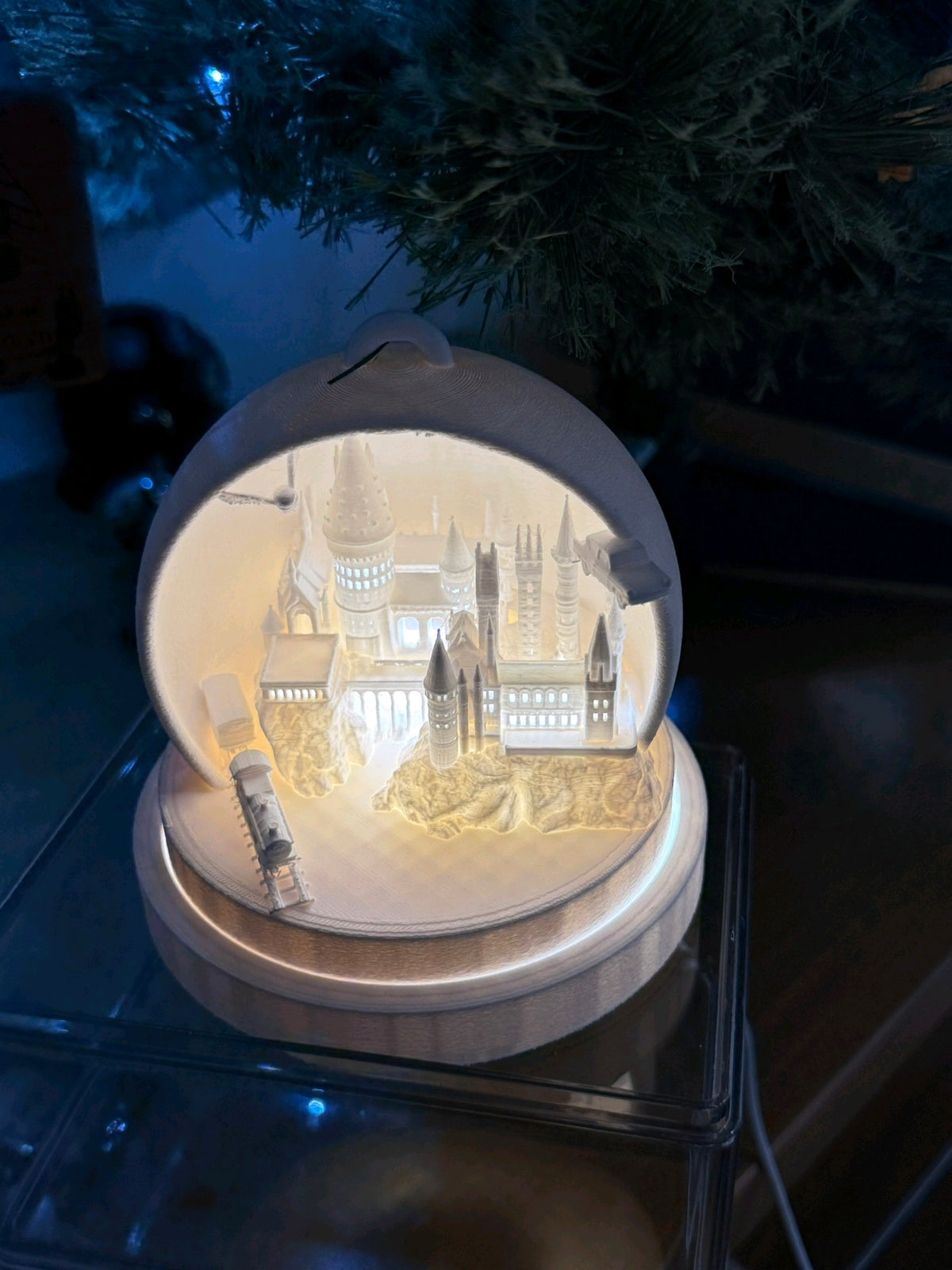 Warmly glowing cathedral tealight holder shown in a softly lit setting