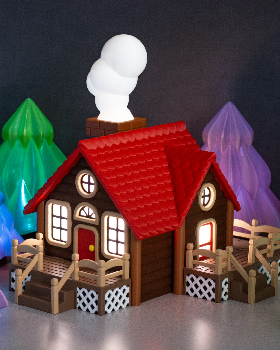 Close view of the red-roofed cabin and chimney snowman