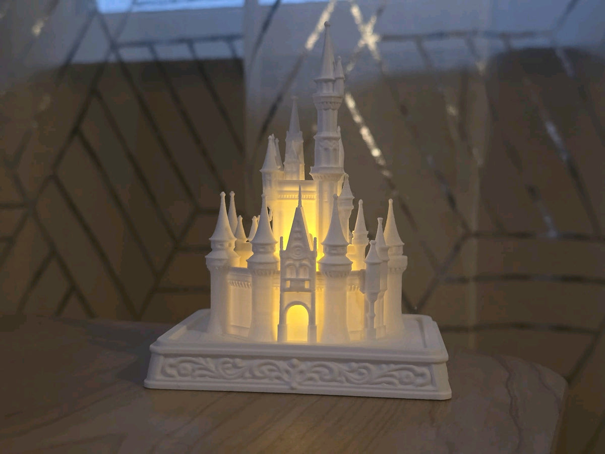 White castle tealight holder glowing warmly on a tabletop in a home setting