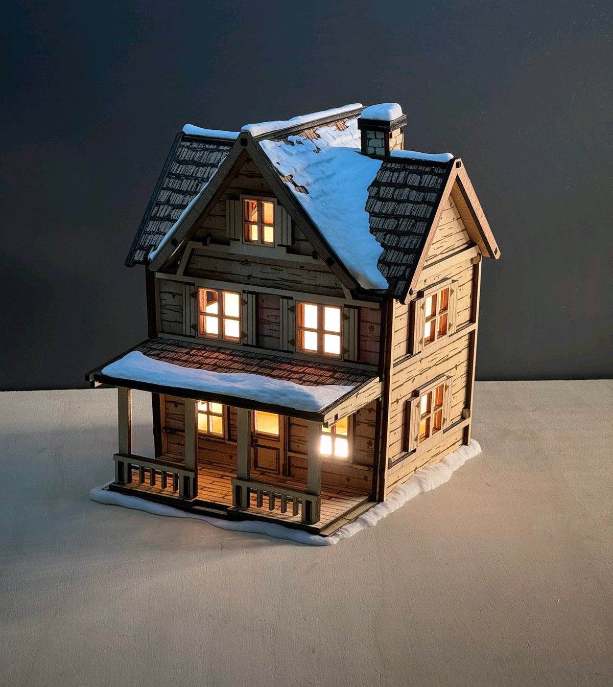 Alternate view of the snowy Tealight House with illuminated windows