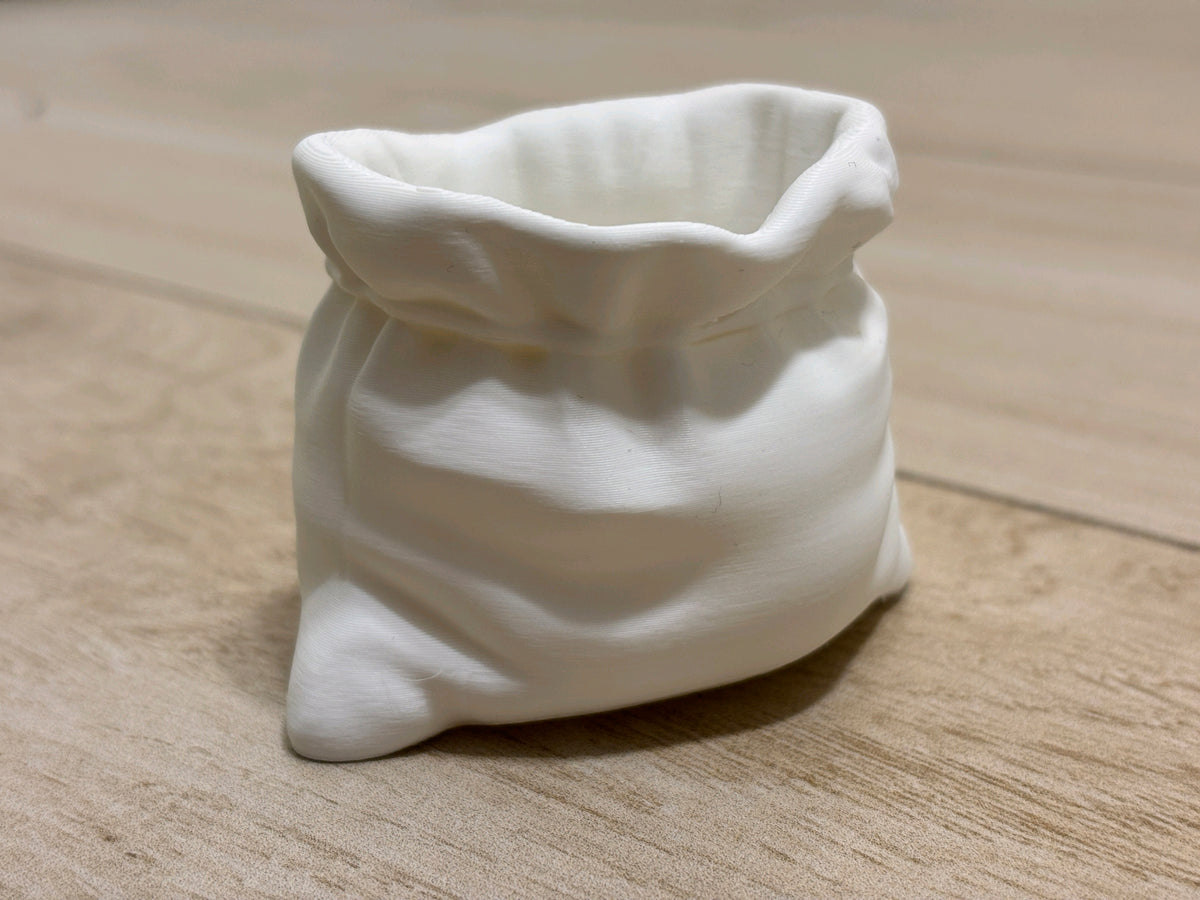 Front view of a white gathered sack-shaped planter