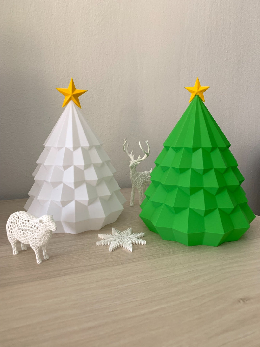 White and green tiered Christmas tree tealight holders with matching gold-coloured star toppers