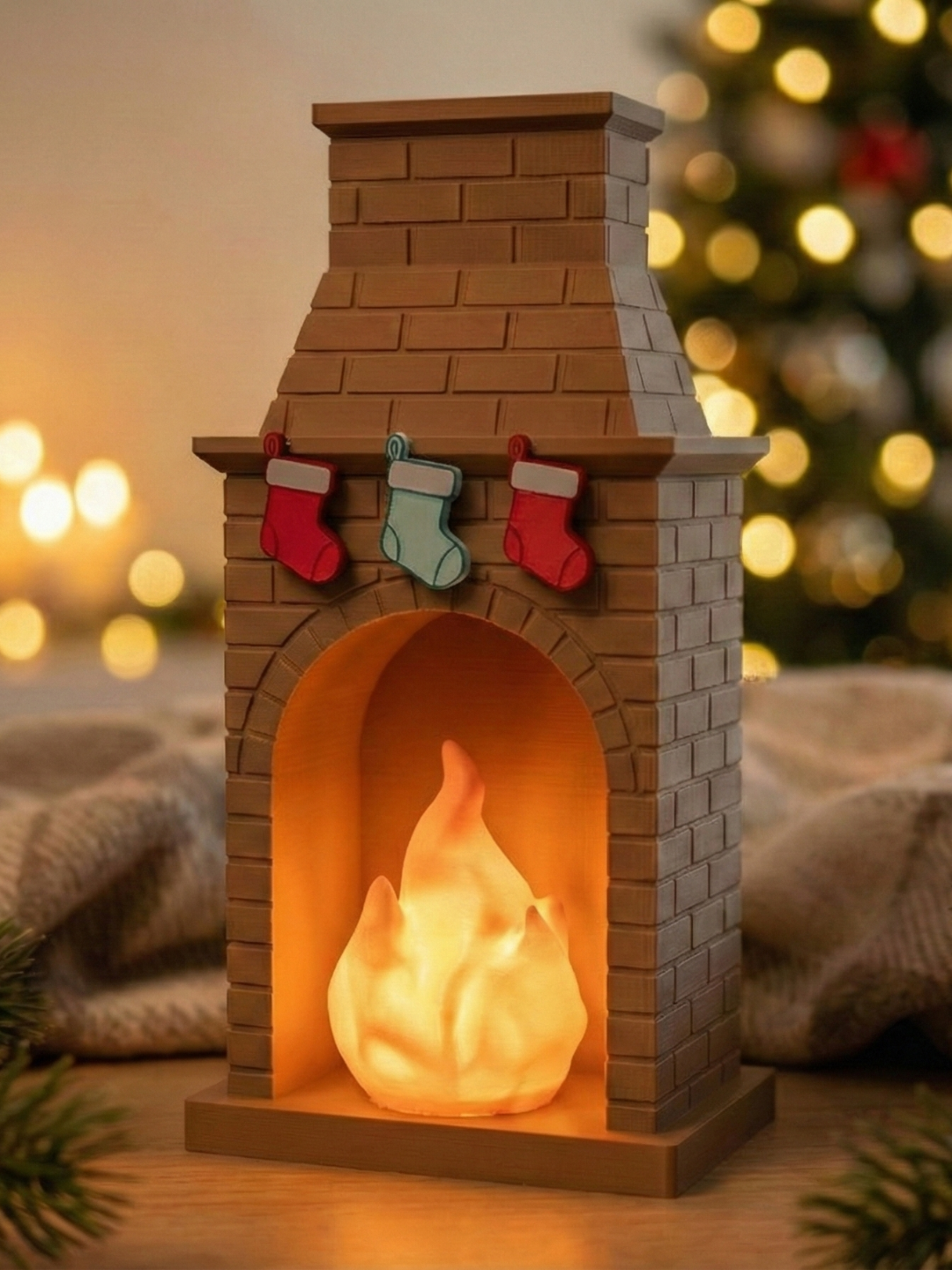 Miniature brown brick fireplace tealight holder with three stockings and a warm central glow