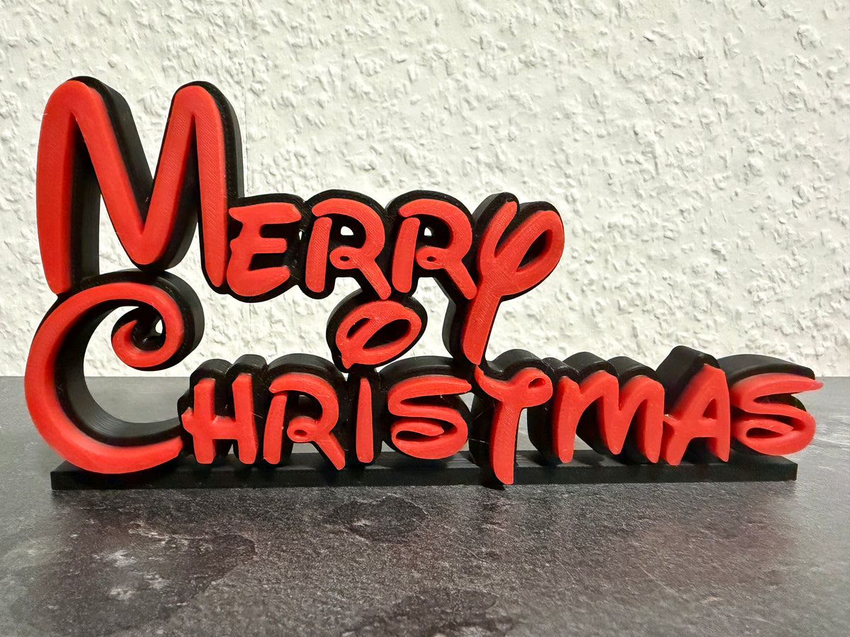 Freestanding Merry Christmas sign with red lettering on a black background and black base