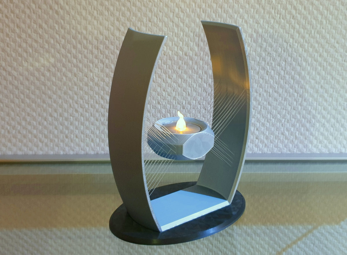Suspended tealight holder shown illuminated with a central cup