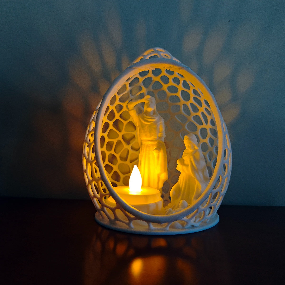 Close view of the white oval Nativity scene with an LED tealight holder