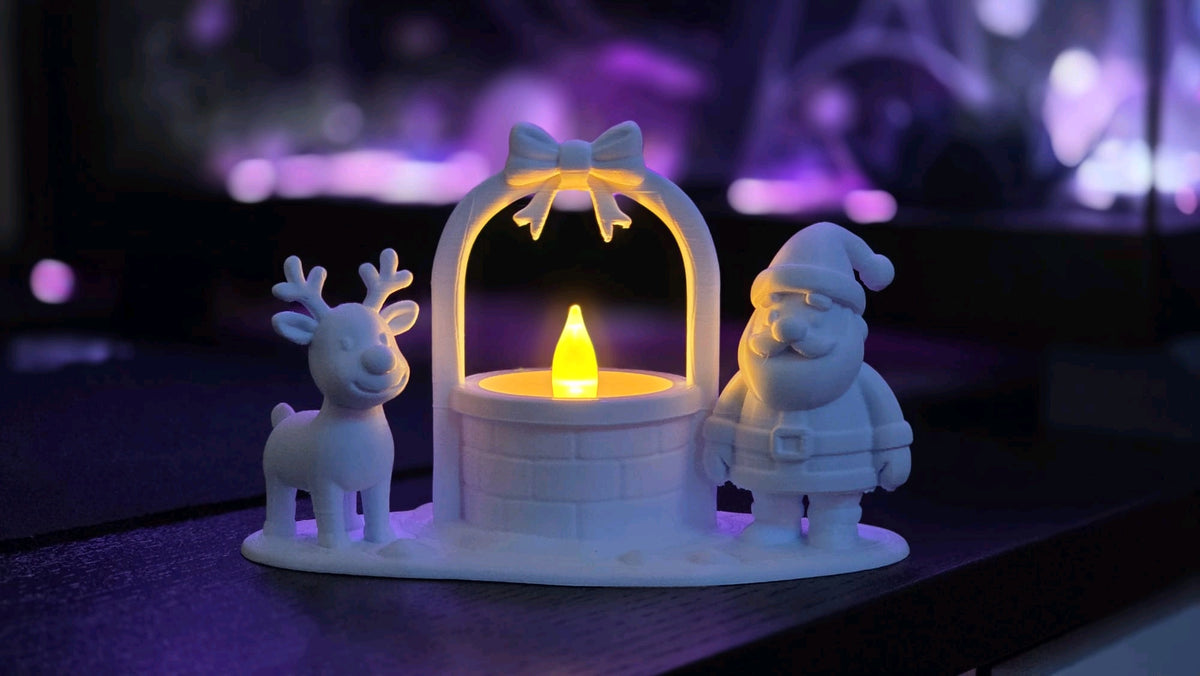 A white reindeer and Santa frame a central tealight well beneath a bow-topped arch
