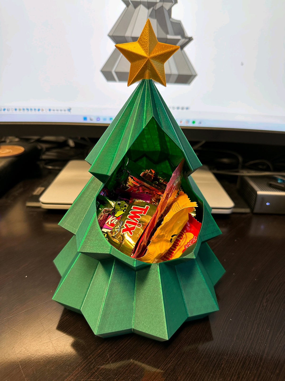 Green Christmas tree snack bowl with gold star and wrapped sweets in the centre
