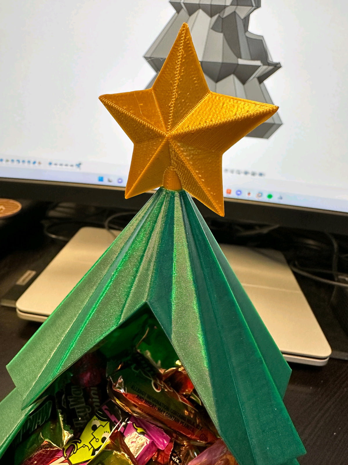 Close-up of the gold star and open treat cavity on the green Christmas tree snack bowl