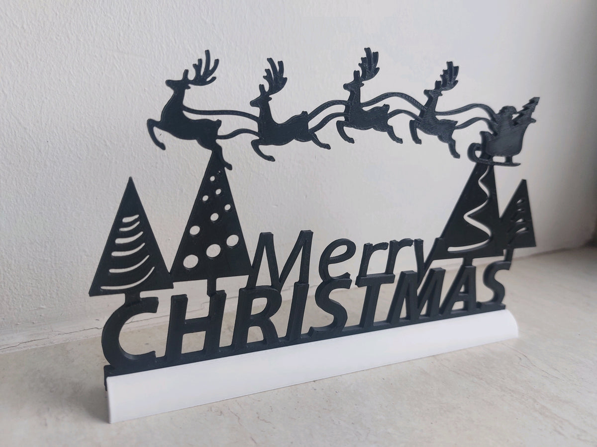 Angled view of the Merry Christmas cut-out sign and its white base