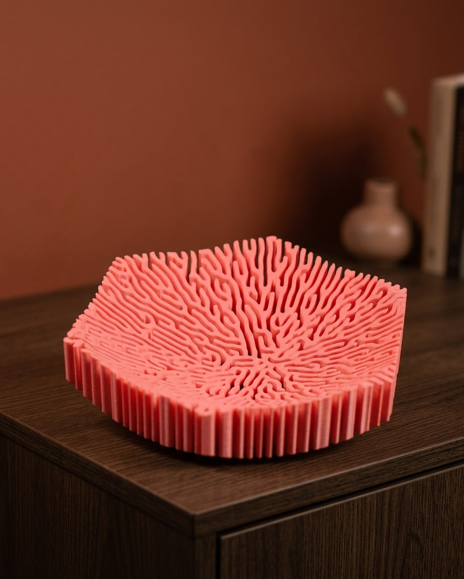 Pink coral bowl with branching interior on white background