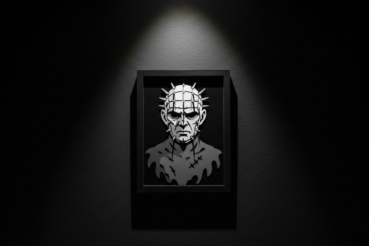 Pinhead Shadow Box hung on a dark charcoal feature wall with dramatic single spotlight illumination