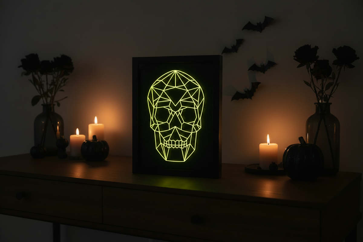 Geometric Glow-in-the-Dark Skull shadow box on a dark moody desk with Halloween decorations and neon green glow
