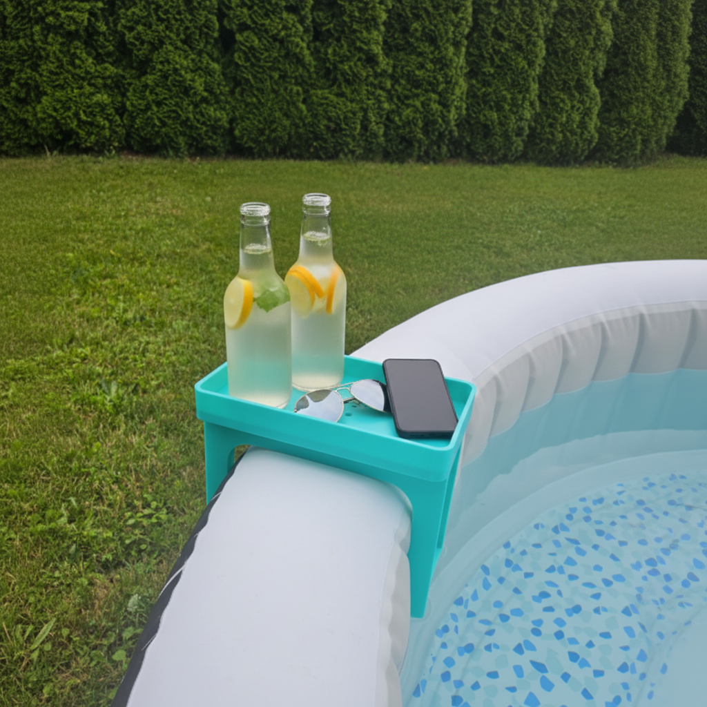 White hot tub caddy clipped onto inflatable hot tub holding drinks bottle, phone and sunglasses in sunny garden