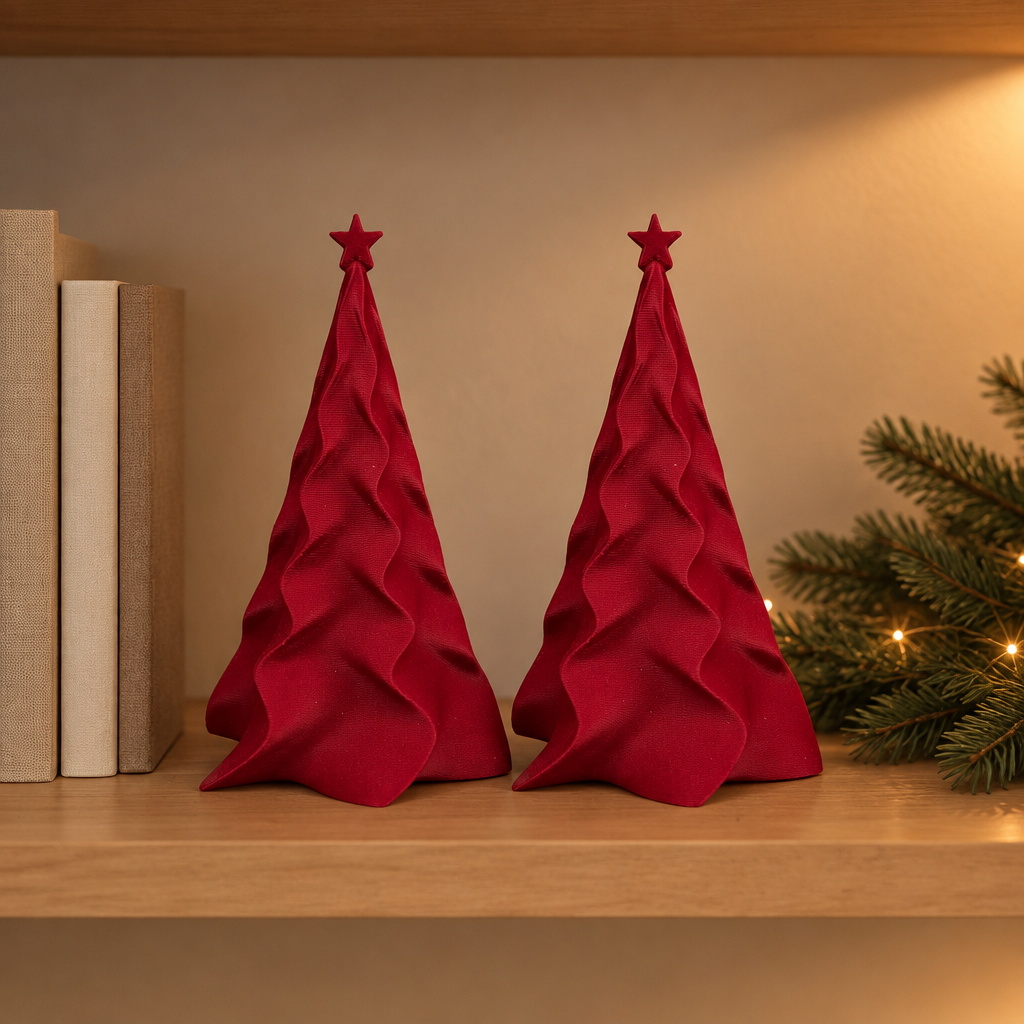 Two matching red folded Christmas trees on a reading-nook shelf