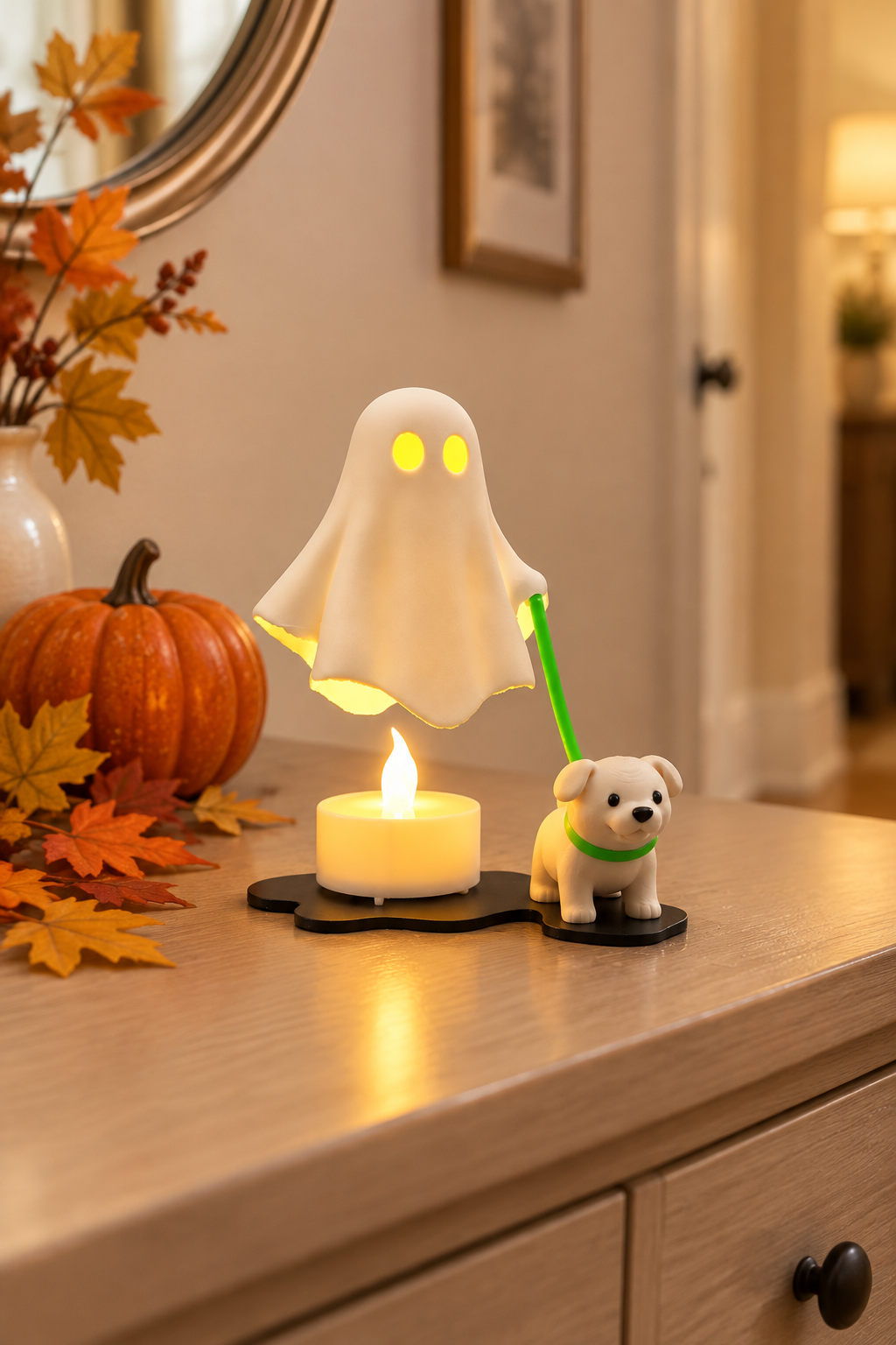White ghost walking a cream puppy with a matching green collar and lead on a hallway console beside autumn leaves and a pumpkin