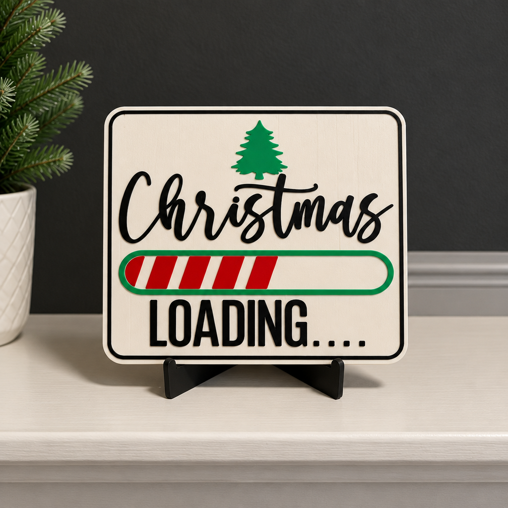 Christmas Loading Sign on its black easel against a dark wall