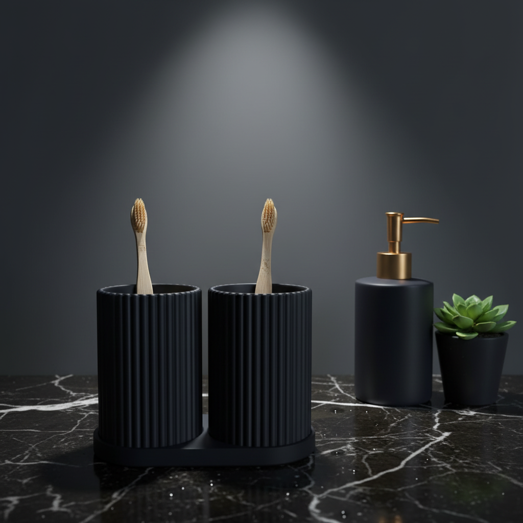 Navy blue ribbed dual toothbrush holder on dark marble bathroom counter with bamboo toothbrushes and luxury soap dispenser