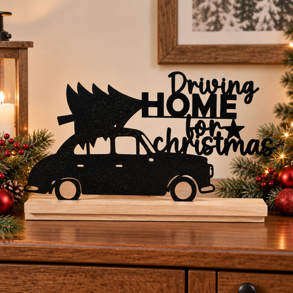 Black Driving Home for Christmas Sign on a festive sideboard with greenery